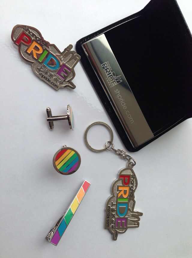 Pin, keychain, tie-pin, cufflinks and namecard holder with the ShanghaiPRIDE logo and PRIDE colors